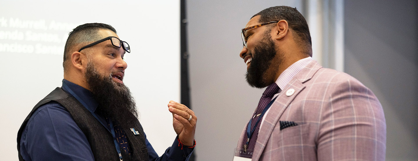 Two members of the Evidence in Action RI team in discussion
