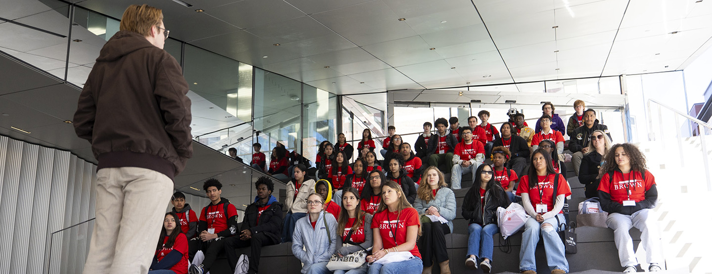 A Brown staff member speaks to incoming postsecondary students