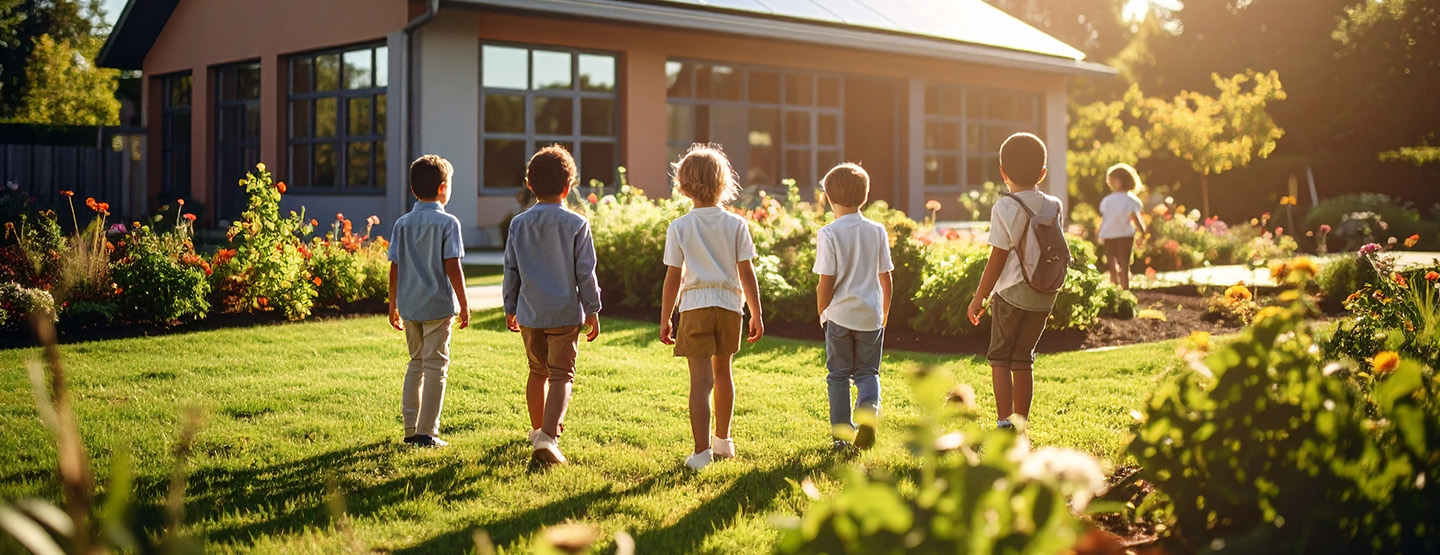 A group of children look at a verdant garden