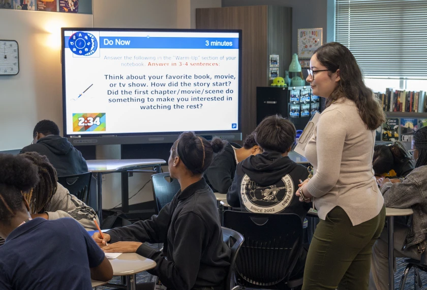 English teacher Jessica Gallo assists students during a writing exercise in her classroom at Dekaney High School in Houston, on Sept. 16, 2025. Newcomer immigrant students in high school with low English-proficiency face multiple barriers schools can address.