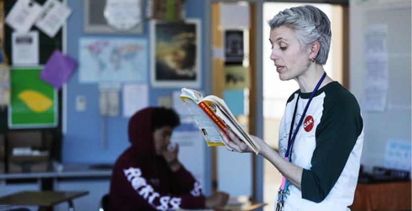 A teacher reads aloud to a classroom