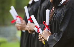 grads holding diplomas