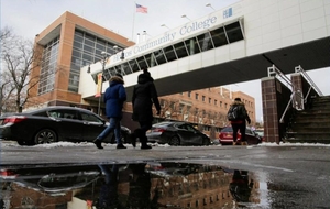 People walk outside Hostos Community College in the Bronx
