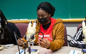Student using a microscope in a classroom