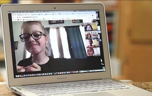 A student in a video class on a laptop