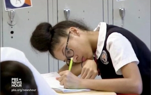 A charter school student working at a desk