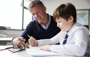 Teacher helping a student with written work