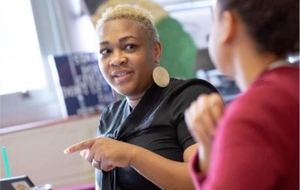 Two teachers talking in a classroom