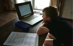 A boy at a laptop during distance learning
