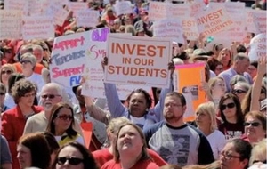 Teachers rallying with Invest in Our Students signs
