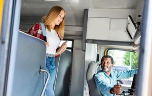 A student boards a school bus